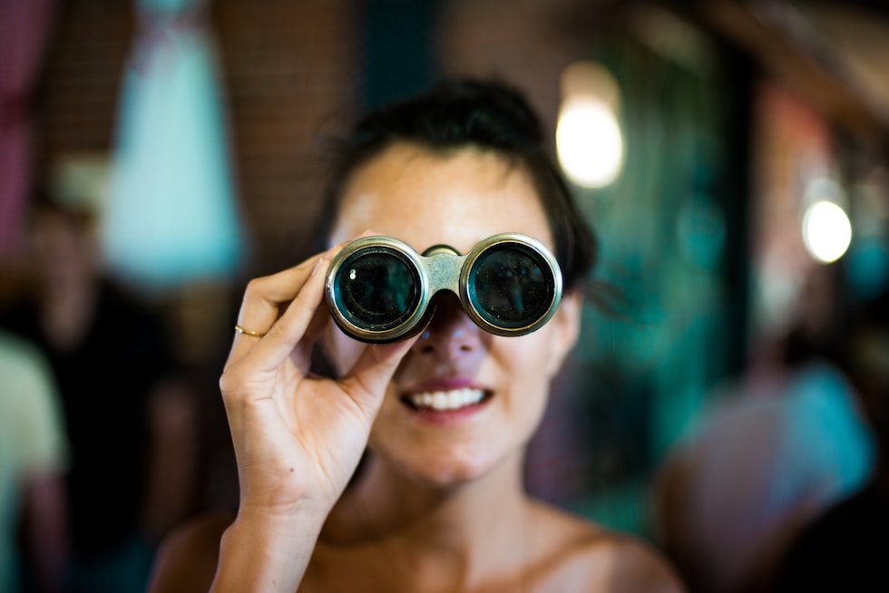 woman using gray binoculars